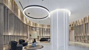 A modern lobby with a curved ceiling, circular light fixtures, and a central column. - Diamonds are Forever! 1Bed/1Bath/ Parking/VIEWS (Brisbane City)