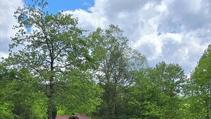 A log cabin with a swimming pool and outdoor seating area surrounded by trees. - Gatlinburg Resort Cabin - Hot Tub, Game Room, Sleeps 6  BOOK NOW FOR FALL COLORS (Gatlinburg)