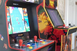 An arcade machine with multiple screens, joysticks, and buttons.