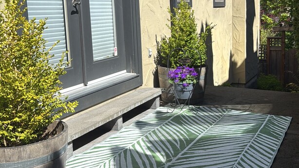 A house with a front door, a welcome mat, a potted plant, and a doormat. - Beautiful Queen Suite near Castle, City & Beach (Victoria)