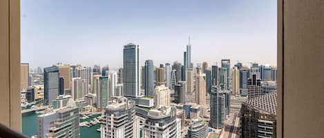 A cityscape with high-rise buildings, a marina, and a clear sky.