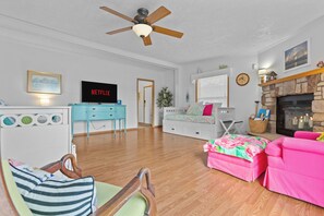 A living room with a television, a fireplace, and a ceiling fan. - Hot Tub & Breathtaking View on Dale Hollow Lake (Albany)