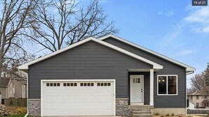 A single-story house with a garage, a front door, and a small porch.