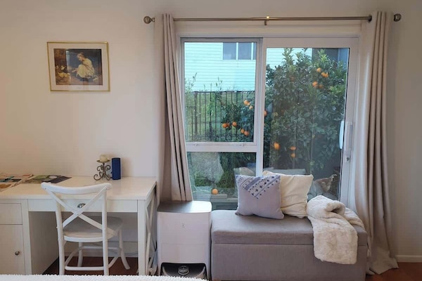 Work desk and bench seat beneath window with garden view