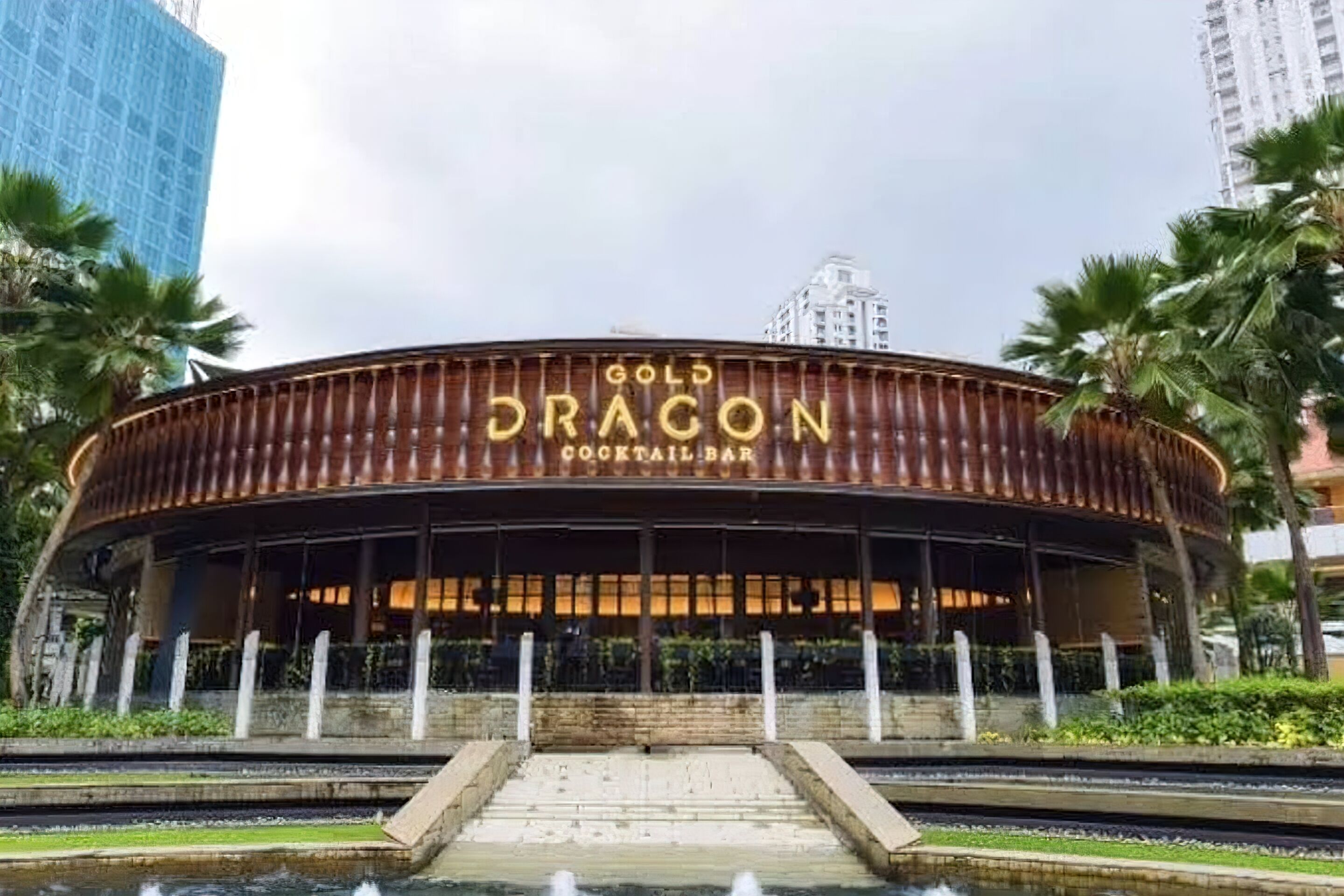 A building with a curved facade and the name "GOLD DRAGON COCKTAIL BAR" prominently displayed.