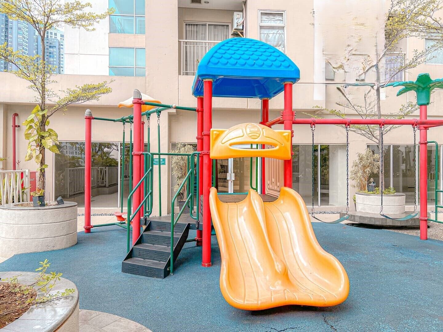 A playground with a slide, climbing structures, and a covered play area.