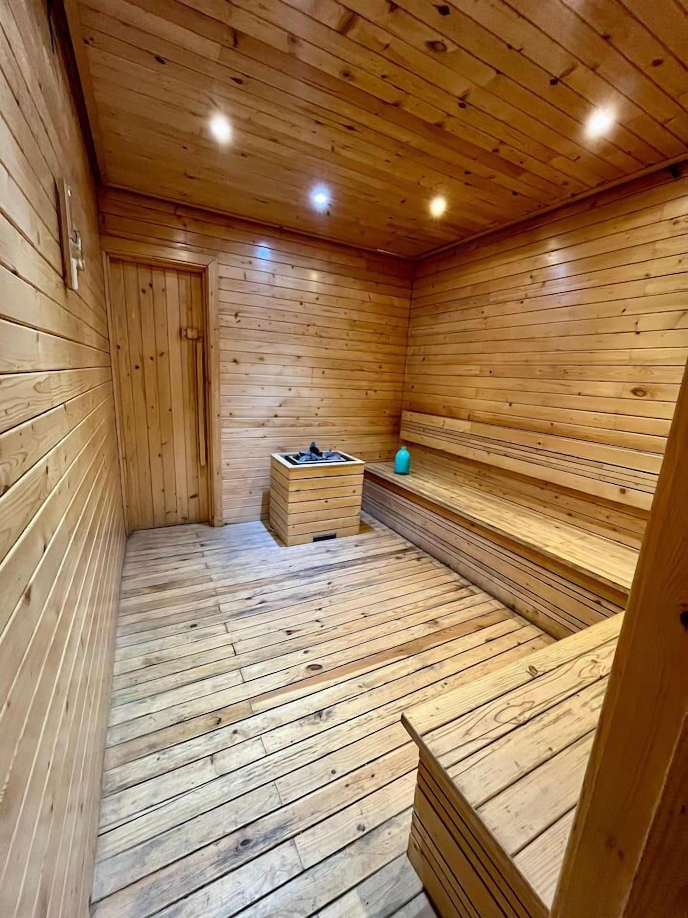 A wooden sauna room with benches and a bench seat.
