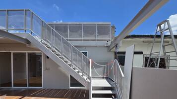 A multi-level outdoor staircase with metal railings and a chain barrier.