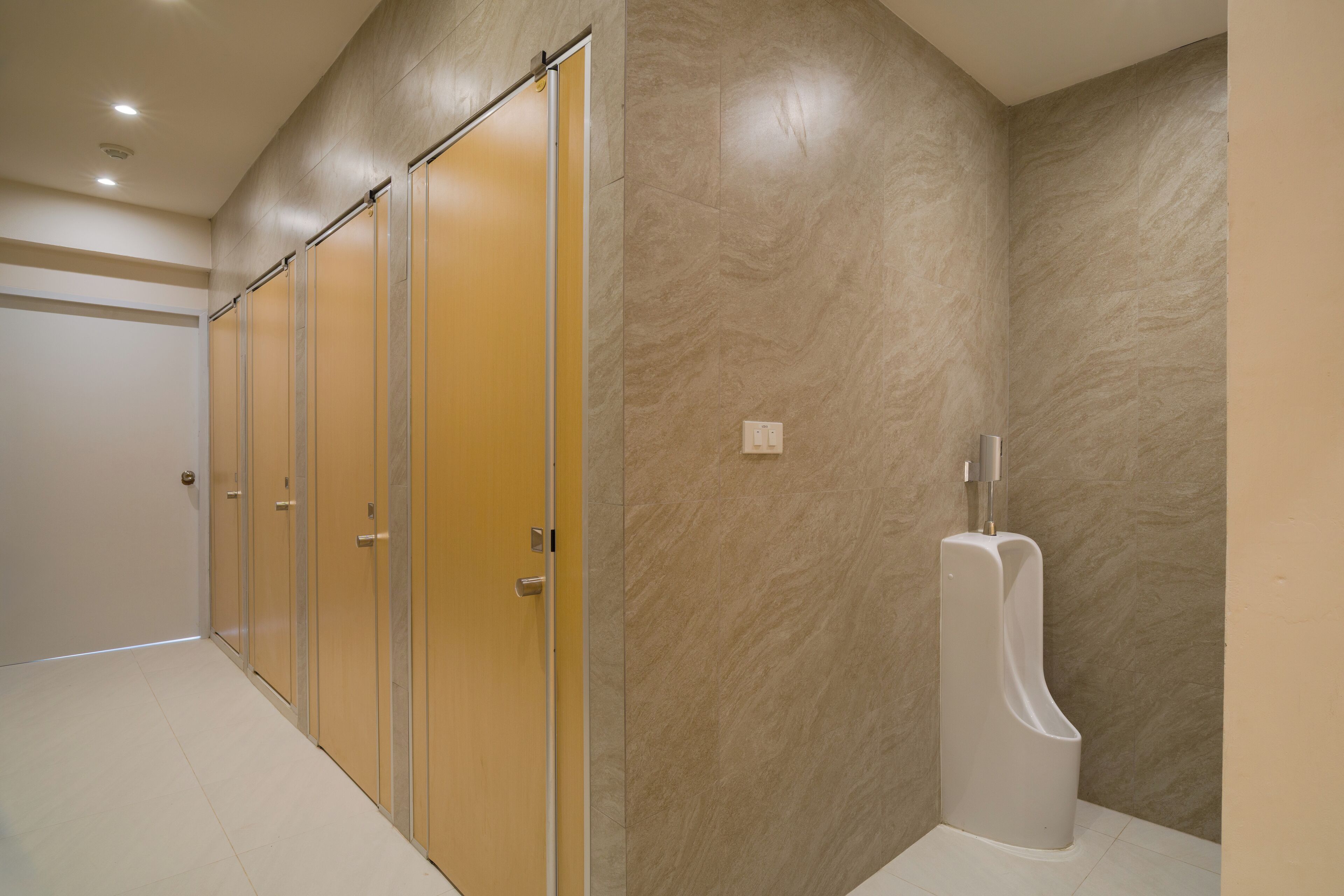A men's restroom with a urinal, a toilet, and a sink.
