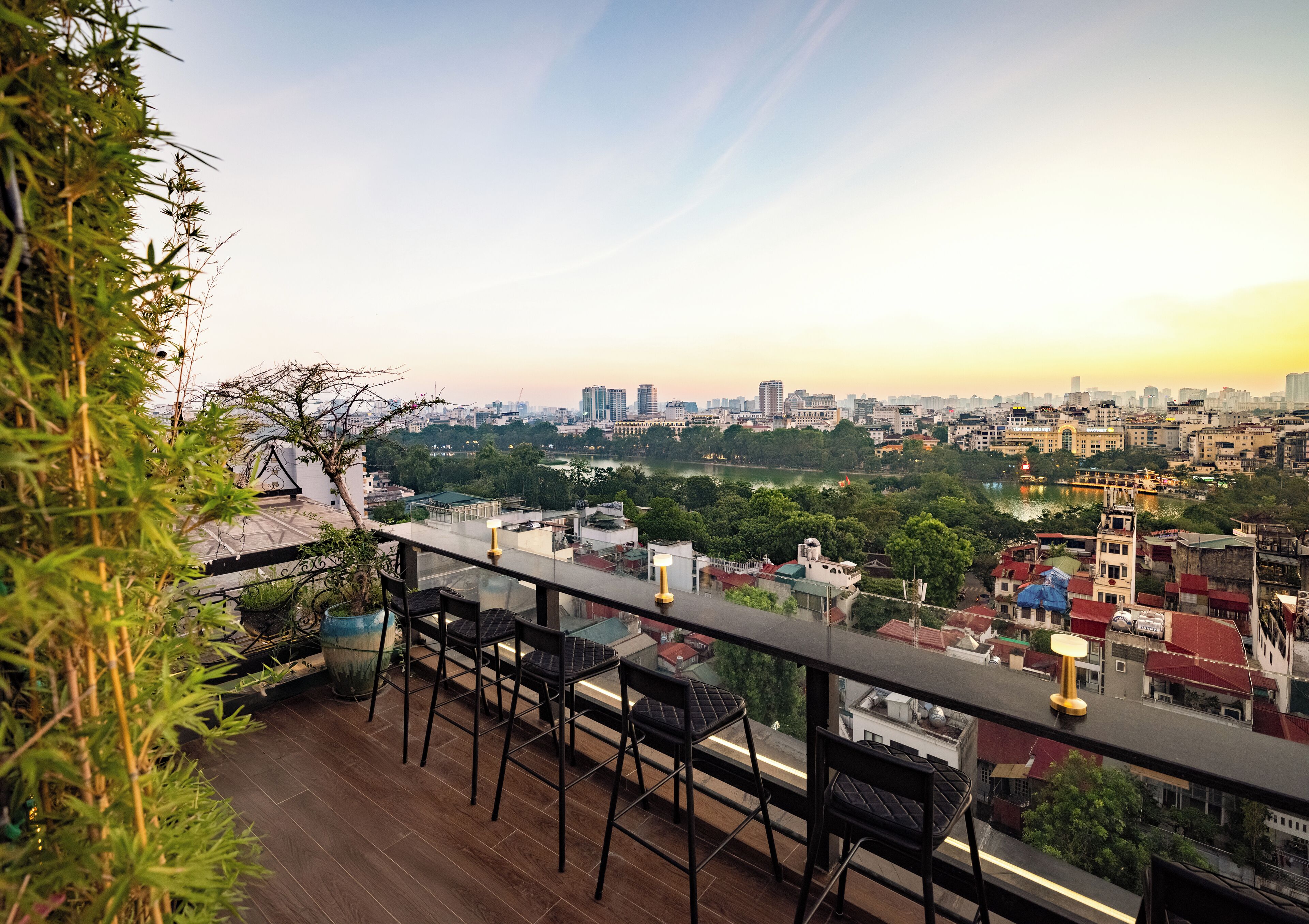 A rooftop terrace with a city view, including a river and buildings.