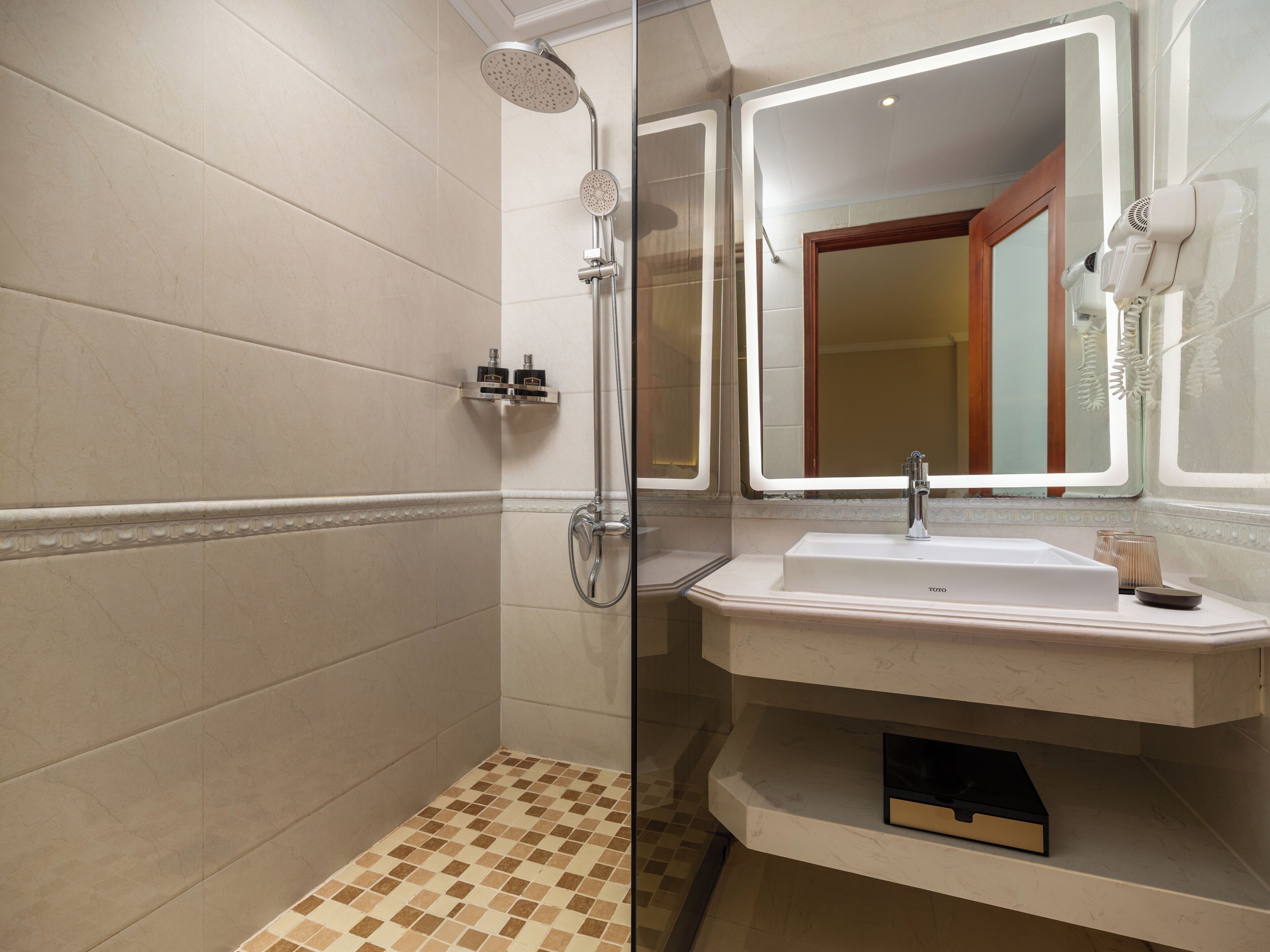 A bathroom with a shower, sink, and mirror.