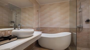 Une salle de bain moderne avec une baignoire sur pieds, un grand miroir et une douche séparée par des parois en verre.
