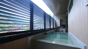 A room with a large window, a bathtub, and a view of a bridge. - Myoukenkan (Kirishima)