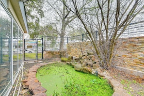 Stroll through the serene garden, surrounded by a tranquil pond and lush greenery.