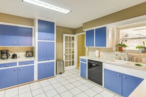 Enjoy cooking in this well-equipped kitchen with a dishwasher, sink, and coffee maker.