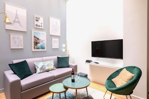 Relax in style with a comfortable sofa, armchair, and flat-screen TV.