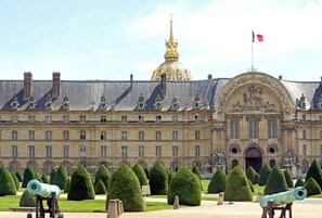 Standing proudly in France, this grand building boasts a central dome and ornate statues.