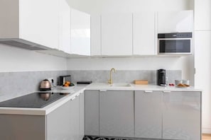 Enjoy cooking in this well-equipped kitchen with an oven, microwave, and induction cooktop.
