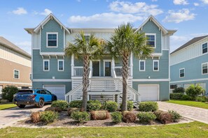 A two-story house with a front porch, palm trees, and a blue SUV parked in the driveway. - New Listing! |Beautiful 4 bedroom villa |Private Beach Club |Pickle Ball |Tennis |2 pools |Golf (Pensacola)