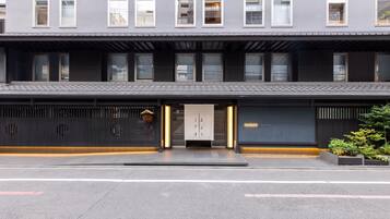 A modern hotel facade with a flat roof, large windows, and a minimalist entrance.