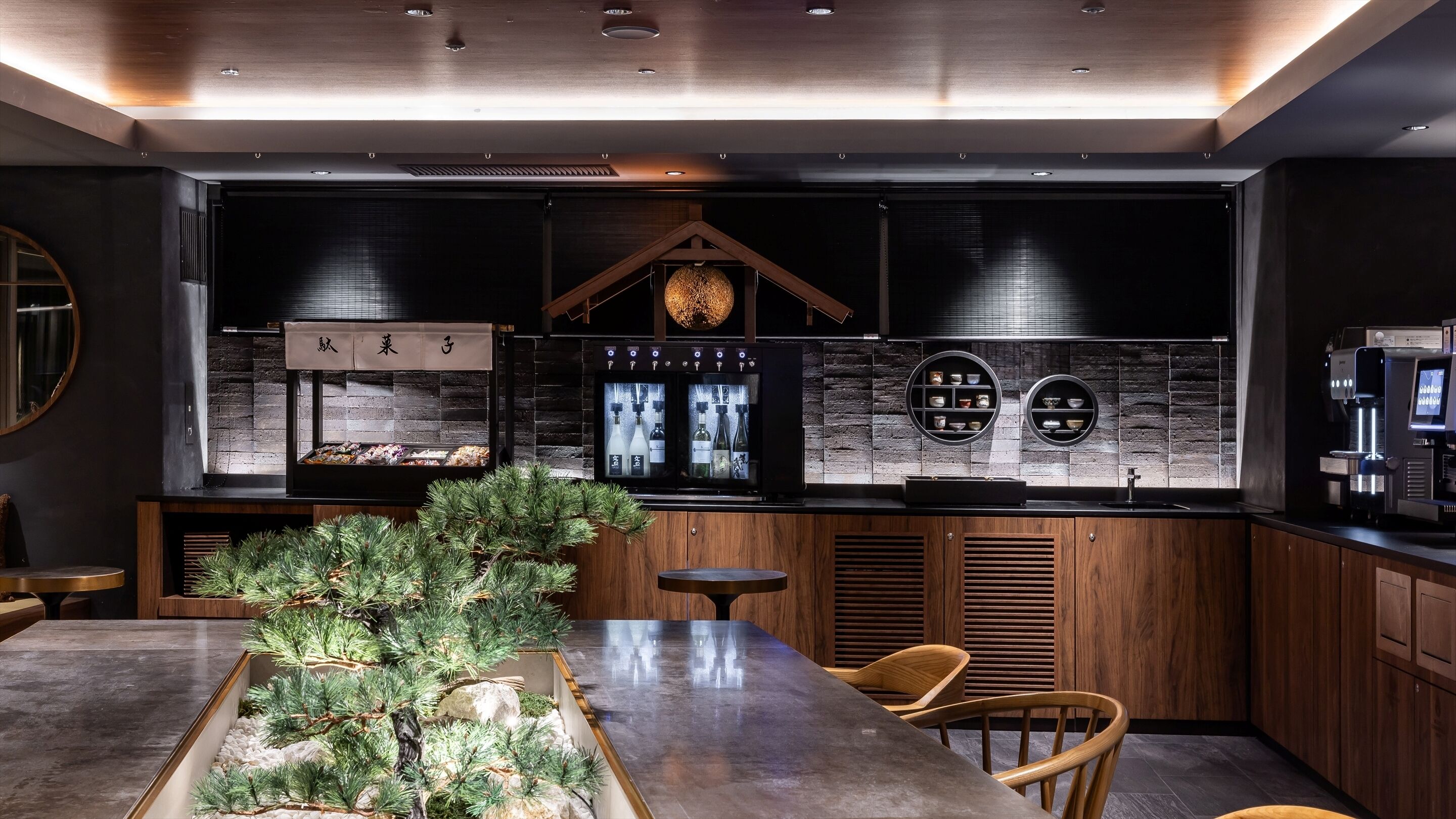 A modern kitchen with a central island, wooden cabinets, and a built-in wine cooler.