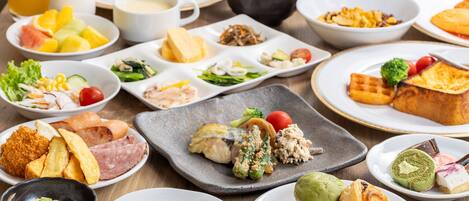 A variety of dishes including bread, salad, and pastries on a table.