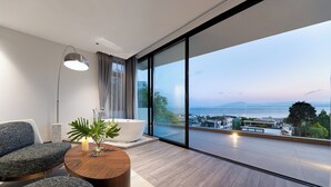 A modern room with a large window, a sofa, a coffee table, and a floor lamp. - Anyu Aranya Collection Sea View Resort Hotel (Dali)