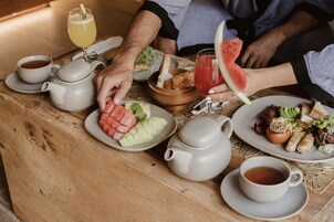 Un desayuno con diversas opciones de comida y bebidas sobre una mesa de madera.