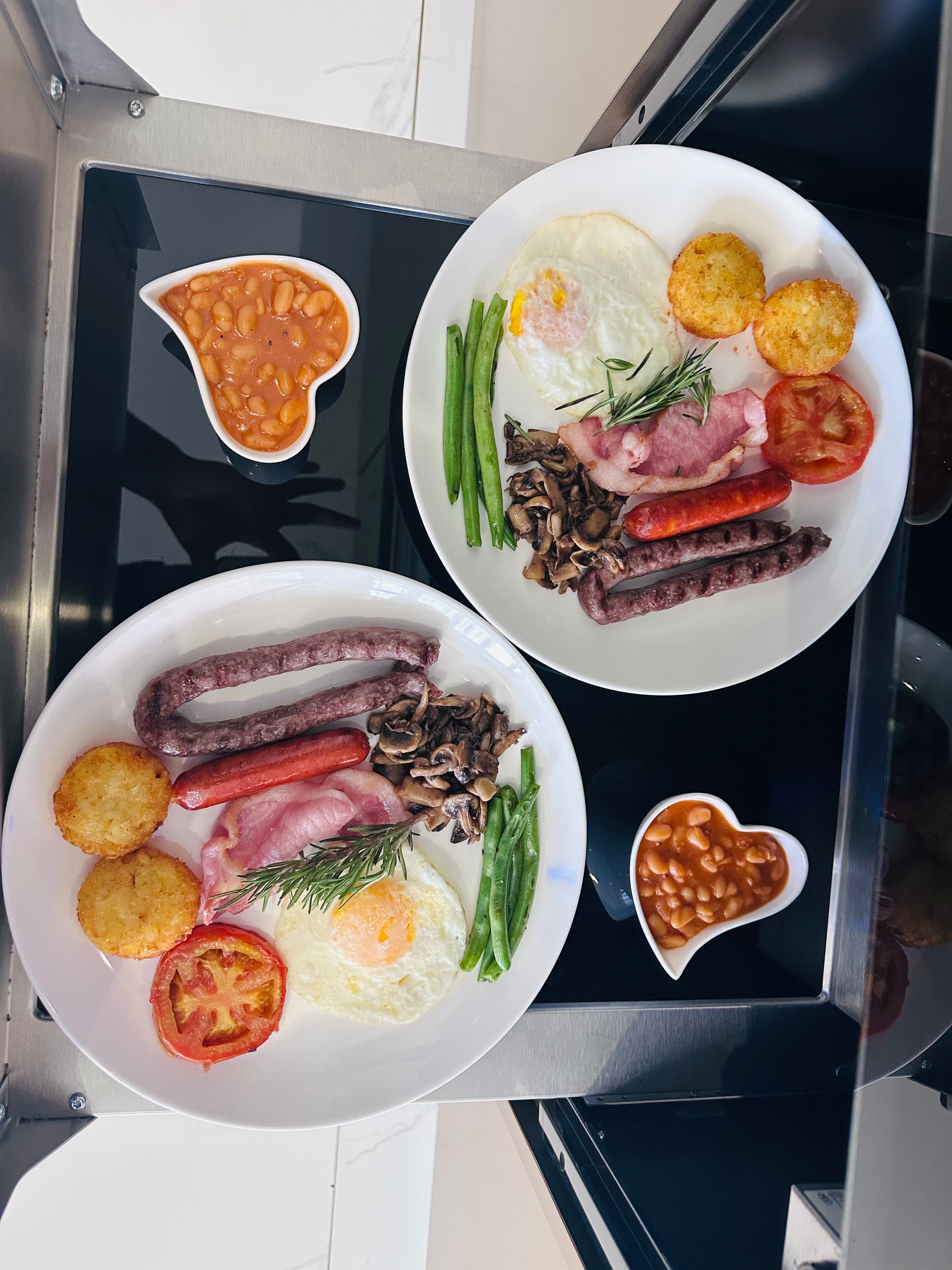Two plates of food on a black tray.