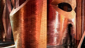 A modern architectural structure with cylindrical and curved elements, featuring a metallic finish and reflective surfaces. - Wanda Yi Hotel Xi'an The Linow (Xi'an)