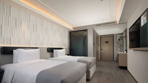 A modern hotel room with two beds, a large mirror, and a wooden floor. - Wanda Yuehua Shanghai Wildlife Park (Shanghai)