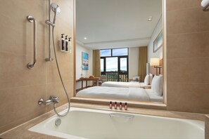 Executive Twin Room | Bathroom | Combined shower/tub, hair dryer, bathrobes, slippers - Wanda Jin Resort Changbaishan (Baishan)