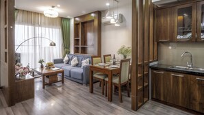 A modern apartment with a dining area, kitchen, and living room.