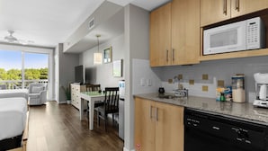 A modern kitchen with wooden cabinets, a built-in microwave, and a dishwasher.