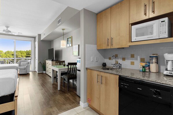 A modern kitchen with wooden cabinets, a built-in microwave, and a dishwasher.