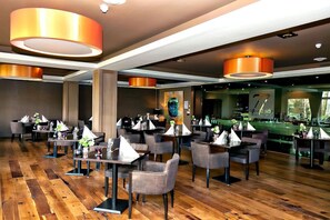 Enjoy dining in a spacious restaurant with comfortable seating and ample lighting.