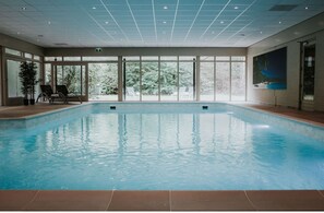 Relax by the pool with a serene view of the surrounding landscape.