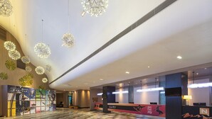 A spacious lobby with a checkered floor, a reception desk, and decorative spherical light fixtures. - Wanda Yue Changbaishan (Baishan)