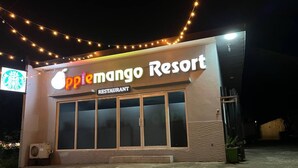 A Mango Resort restaurant with a large glass facade and a sign above the entrance. - Apple Mango Resort (Silang)