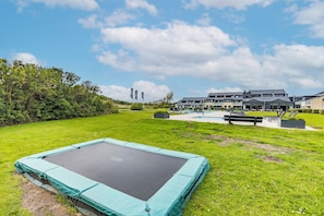 Enjoy a family-friendly atmosphere with a trampoline and lush surroundings.