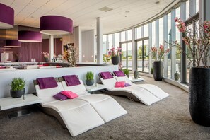 Relax in a comfortable space with lounge chairs and a reception area, perfect for unwinding or waiting.