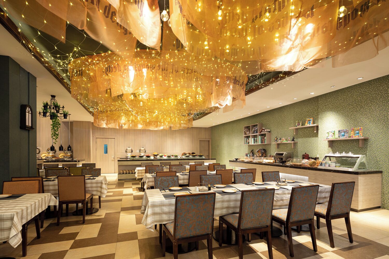 A restaurant with tables set for dining, a kitchen area, and a bar.