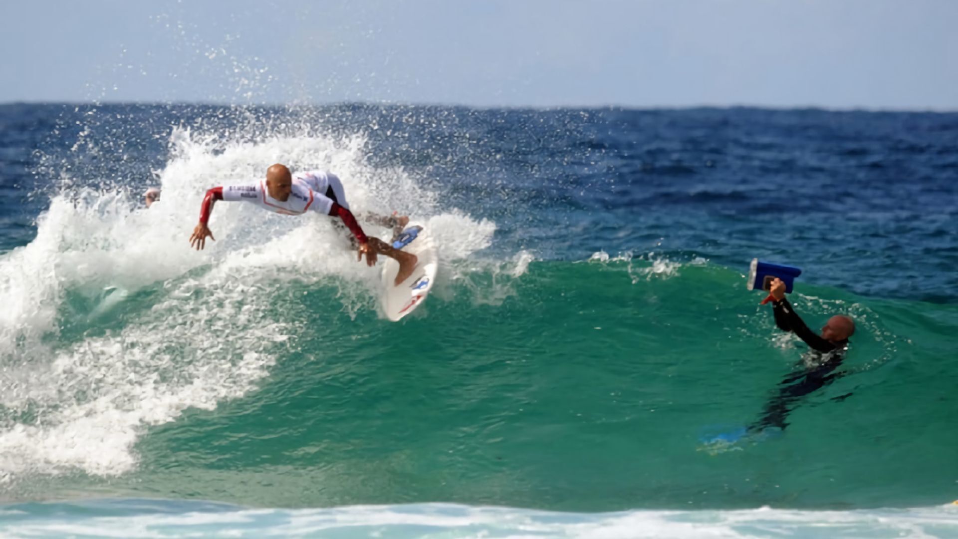 A surfer riding a wave in the ocean.