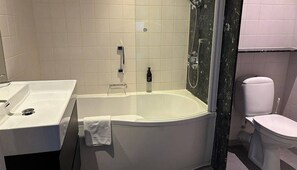 Bathroom features a bathtub, sink, and toilet with a simple, functional design.