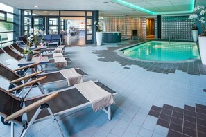 Relax by the pool with lounge chairs and towels at hand.