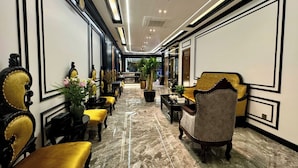 A hotel lobby with a marble floor, ornate furniture, and a modern ceiling design. - Royal Hanoi Hotel  (Hanoi)