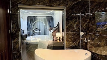 Luxury Suite, Balcony, City View | Bathroom | Combined shower/bathtub, hair dryer, slippers, towels