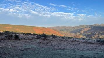 A landscape with rolling hills and a clear sky.