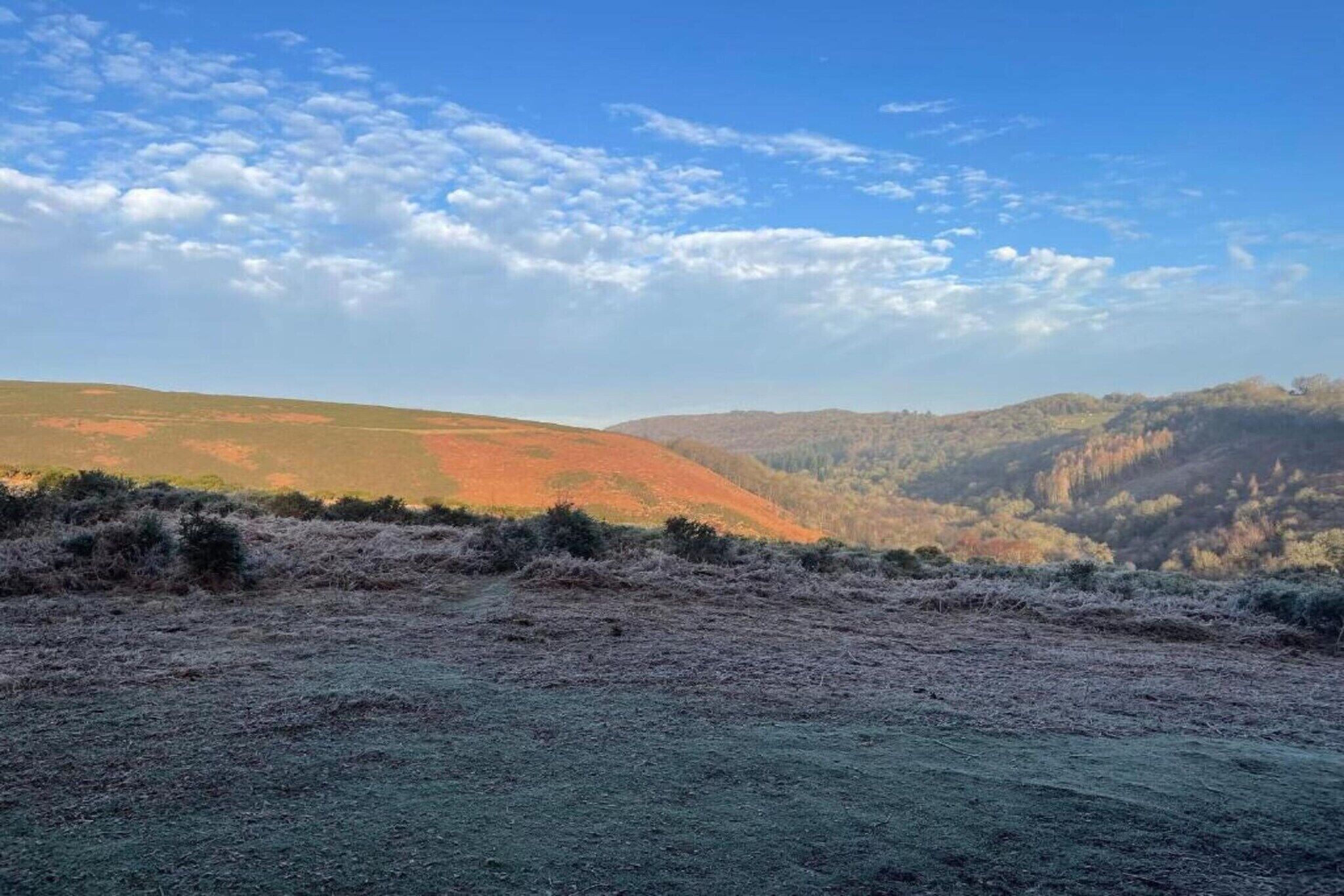 A landscape with rolling hills and a clear sky.