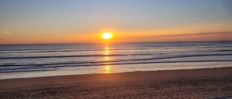 Enjoy a serene beach experience with a walkway offering stunning views of the ocean.